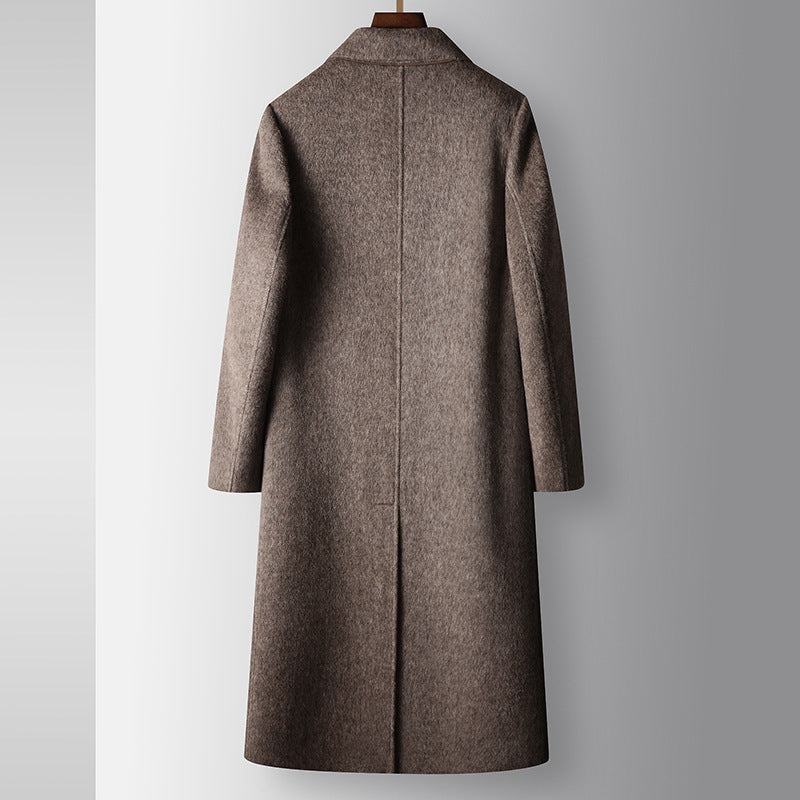 Brown coat on a hanger against a gray background