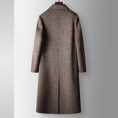 Brown coat on a hanger against a gray background