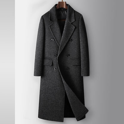Gray overcoat on a hanger against a light gray background