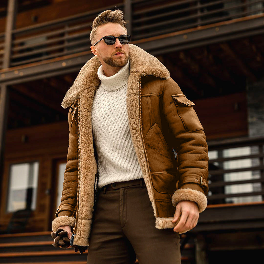 Man wearing a brown shearling jacket and sunglasses outdoors.