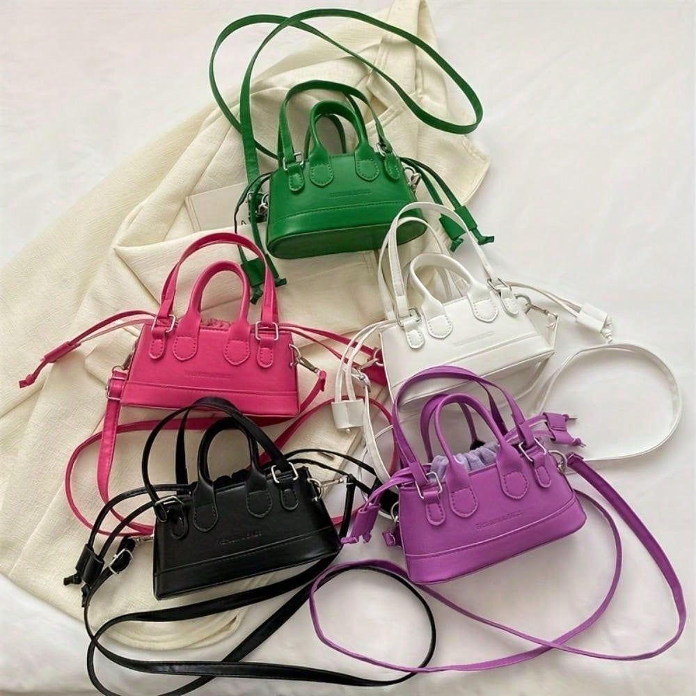 Five colorful mini handbags on a light background