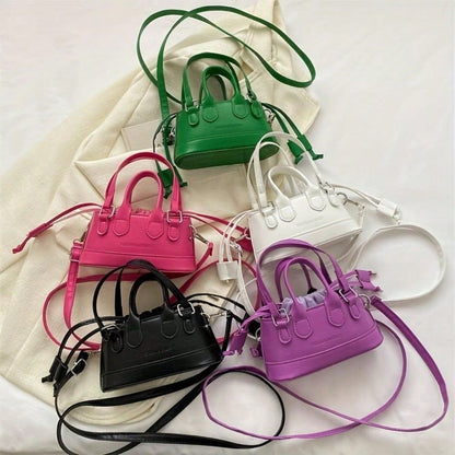 Five colorful mini handbags on a light background
