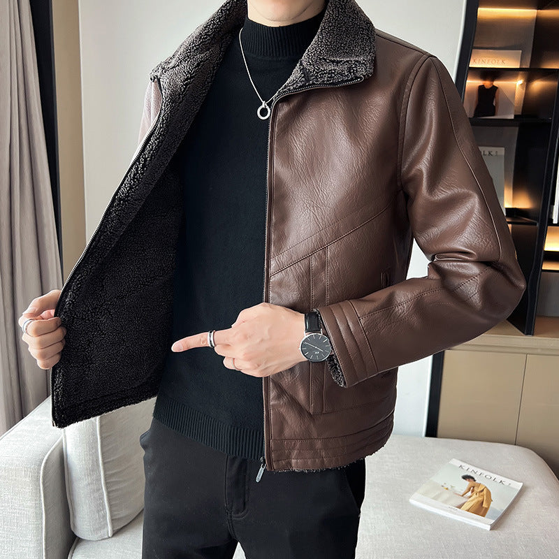 Person wearing a brown leather jacket with a textured collar in an indoor setting.